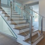 minimalistic glass system with stainless baserail handrail and posts