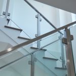 minimalistic glass system in brushed stainless from landing to 3rd story