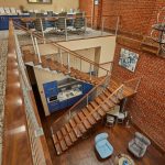 maple floating staircase in powder coat silver looking over a balcony